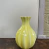 This vintage vase offers a pop of color and bohemian flare to