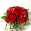 A collection of miniature spray roses,eucalyptus, and holiday ornaments arranged in a
