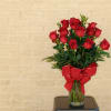 18 long Stem roses with greenery adorned with a large red bow.