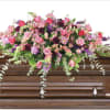 An elegant casket arrangement that has an array of beautiful flowers.

A unique