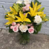 Flower arrangements with Yellow Lilys, pink spray roses, solidego, veronica, roses and