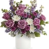 A beautiful bouquet of white and lavender in a white cylinder