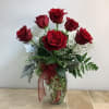 Six fresh long-stemmed red roses beautifully arranged in a diamond cut clear