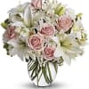 An exquisite bouquet of roses, lilies, alstroemaria, pompons and filler flowers. Just