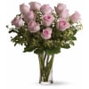 A dozen pink roses with variegated pittosporum and salal in a beautiful