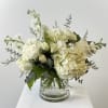 Simply Pure has white hydrangeas, white roses and white spray roses, white