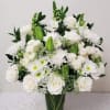 A serene arrangement of pristine white blooms nestled in a glass lined