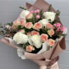 A stunning bouquet wrapped in premium paper features white and pink roses