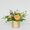 Modern gold pot filled with seasonal blooms &amp; foliage.