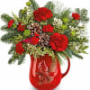 Teleflora&#039;s Festive Flight Bouquet spreads holiday cheer with red blooms, winter greens