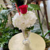A hydrangea and rose in a soda glass, a floral replica of