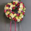 This beautiful arrangement is totally covered in an assortment of roses, mums
