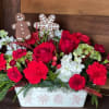 This delightful holiday arrangements combines the joy of floral artistry with the