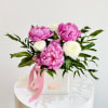 Elegant arrangement of pink Peonies, white Ranunculus and vibrant Italian Ruscus, in