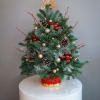 Natural pine mini-Christmas tree in a ceramic vase. Includes lights and decoration.