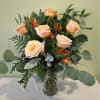 Arranged in clear glass vase, beautiful peach roses.  Our roses are