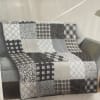 50 x 60. Quilt with floral pattern with gray and white color
