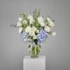 This graceful vase arrangement exudes serenity and sophistication with its soft palette
