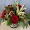This collection of lilies and roses is complete with Jersey pinecones and