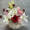 A soft and romantic mix of lilies, roses, daisies, and mini carnations