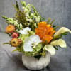 A refined autumn arrangement blending white orchids, calla lilies, hydrangeas, snapdragons, and