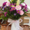 &ldquo;A cheerful arrangement featuring soft pink roses, white lilies, and playful daisies
