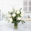 Luxe White Roses Bouquet is a sophisticated and elegant floral arrangement featuring