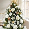Tree shaped arrangement with white roses cushion palms and carnations accent with
