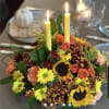 Enjoy a candlelit dinner with this colorful arrangement that embraces every shade