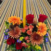 Beautiful single candle centerpiece for the table filled with seasonal fresh fall