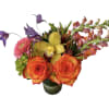 Orange roses, snapdragons, gerbera daisy, green hydrangea designed in a glass vase.