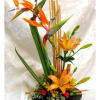 This nice arrangement consists of orange roses, orange lilies and bird of