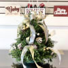 Bring a winter wonderland indoors with a decorative boxwood tree trimmed in