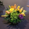 A bright fall bouquet in a low vase for your dining table