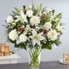 This stunning flower arrangement is in a traditional clear glass vase. A