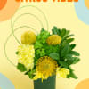 A modern mixture of yellow and green seasonal blooms.