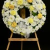 Beautiful sympathy wreath crafted with fresh white mums, accented with soft yellow
