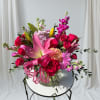 Elegant design using bursts of vibrant pink flowers such as roses, lilies