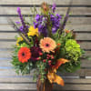 Designers choice of seasonal fall flowers reflecting the Thanksgiving season arranged in