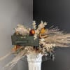 This one of a kind dried arrangement is bursting with dried floral