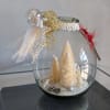 Teardrop shaped vase with white holiday trees dusted in snow a perfect