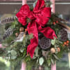 A Wreath that measures 16&quot; across featuring Evergreens,  Velvet Ribbon, Sticks