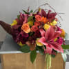 Capture the vibrant spirit of fall with our stunning Lily Cornucopia. This