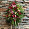 Offer thoughtful condolences with a standing spray of lilies, tropicals, roses, cartations.