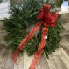 An evergreen wreath with a beautiful ref bow. Let us know if