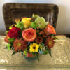  A beautiful assortment of mixed fall flowers artistically designed in a