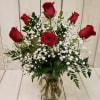 Half Dozen Long Stem Beautiful Roses nestle in greenery. The perfect way