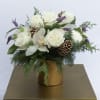 A mix of lush white roses, ranunculus, Orchids, with a pop of