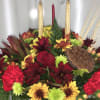 Holiday centerpiece with two tapered candles - colors and flowers may vary