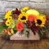 A long and low wooden box makes a perfect centerpiece, filled with